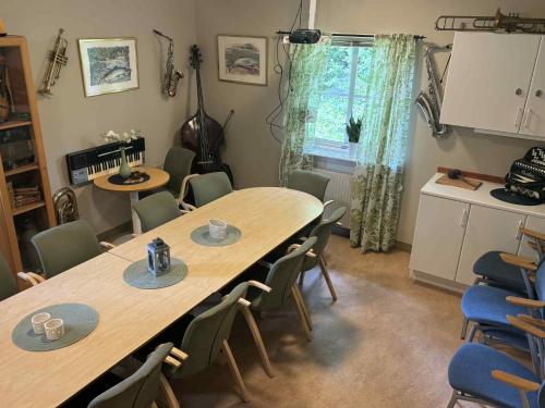 a room with two tables and chairs and a kitchen at Hälsokällans Bed and Breakfast in Kyrkhult