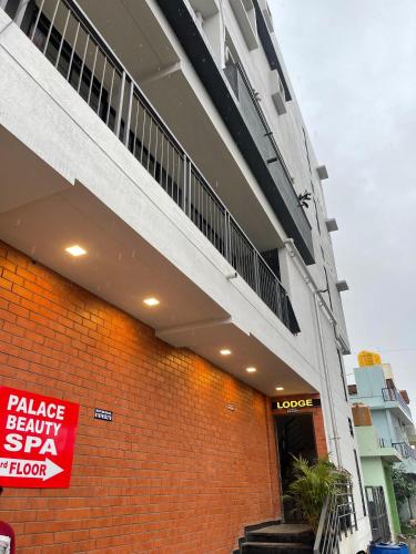 a building with a sign on the side of it at Lavish Hotel BG-Lodge in Bengaluru