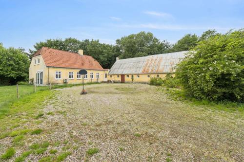 an old house and a barn in a field at Bright Holiday Home With Garden And Togetherness in Varde
