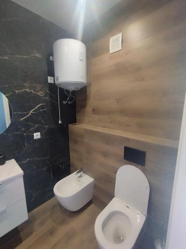 a bathroom with a white toilet and a sink at Vento di Sicilia in Carini