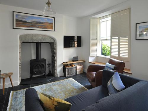 a living room with a couch and a fireplace at Cornerstones in Ambleside