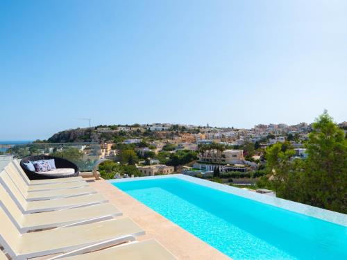 a villa with a swimming pool and a view at Villa Ghea - Indoor Jacuzzi Pool, Sauna and Games Room in Mellieħa