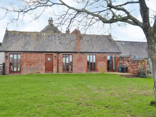 an old brick house with a grass yard in front of it at The Coach House - 15661 in Tytherton Lucas