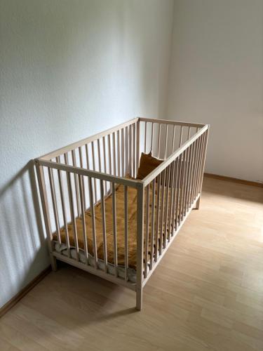 a crib with a pillow in a room at Ferienwohnung Hennes in Remagen