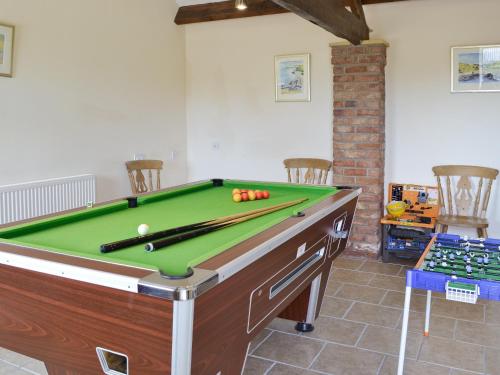 a pool table with balls on top of it at Shyre Stable - 18437 in Bempton