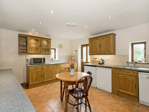a kitchen with wooden cabinets and a wooden table at Dipper Fold in Hebden