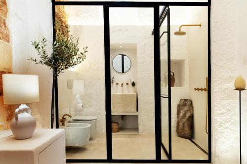 a bathroom with a shower and a toilet in a room at Corte Manfredi in Alessano