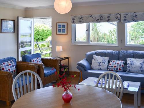 a living room with a couch and a table and chairs at Treyarnon in St Merryn
