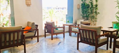 a group of chairs and tables in a room at Sentido Marillia Resort & Spa in Hammamet