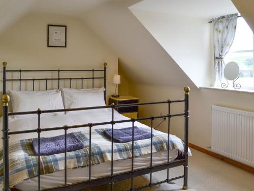 a bedroom with a bed in a attic at Hume Orchard Steading in Hume