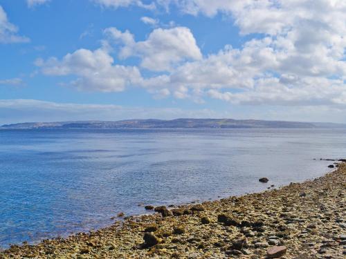 a large body of water with a rocky beach at Crubisdale in Blairmore