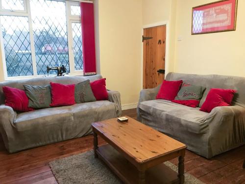 a living room with two couches and a coffee table at Isabella Cottage in Heddon on the Wall