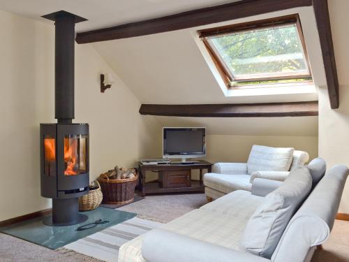 a living room with a fireplace and a couch at The Mill in Mungrisdale