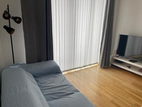 a bedroom with a bed and a flat screen tv at Stylish 2Bedroom Flat - City Centre - Near Leeds Station in Leeds