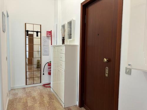 a room with a door and a refrigerator in a room at Casa Lina Nolo - M2 - San Raffaele in Milan