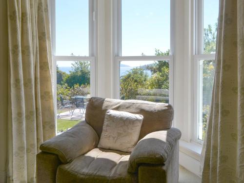 a couch sitting in front of a large window at Fairview in Rockcliffe