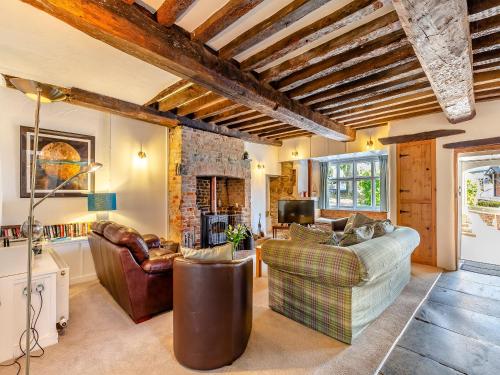 a living room with a couch and a fireplace at Jalna in Stratton
