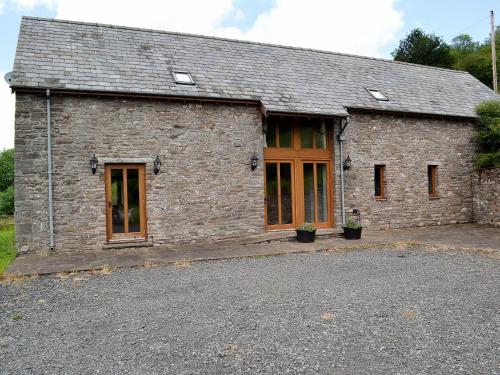 a brick building with glass doors and a lot of windows at Chalgrove in Aber-Brân