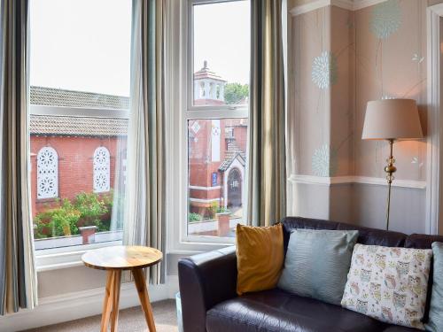 a living room with a couch and a large window at Deja Blue in Filey