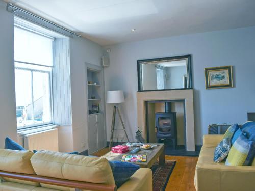 a living room with a couch and a table at St Andrews in Pittenweem
