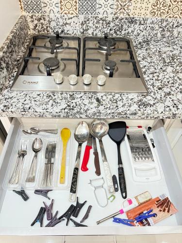 a drawer filled with utensils on a kitchen counter at La Casa Luminosa 3 in Larache