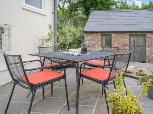 a table and four chairs on a patio at The Milking Parlour in Llangeler