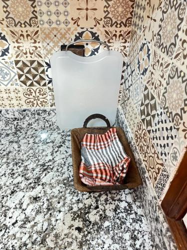 a purse and a box on a floor with tiles at La Casa Luminosa 3 in Larache