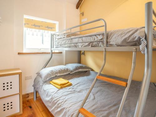 a bunk bed in a small room with a bunk bed gmaxwell gmaxwell gmaxwell at The Milking Parlour in Llangeler