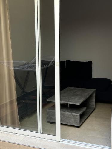 a sliding glass door with a table and a couch at La Casa Luminosa 3 in Larache