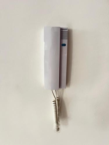 a white phone is hanging on a wall at La Casa Luminosa 3 in Larache