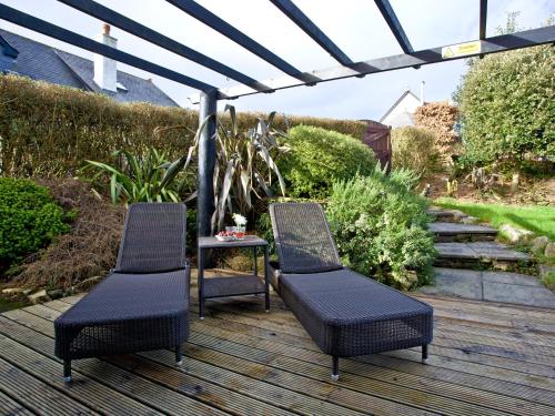 two chairs and a table on a wooden deck at Holly in Saint Wenn