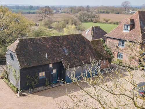 an aerial view of a house in a field at Woolhouse Barn in Hunton