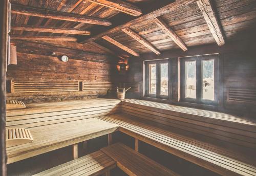 an empty sauna with wooden walls and windows at Hotel Elisabeth, 4 Sterne Superior in Kirchberg in Tirol