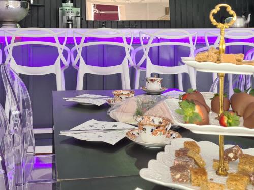 a table with plates of food on a purple at The Golden Crown in Tarbolton