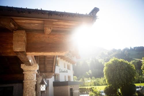 a view of a building with a mountain in the background at Hotel Elisabeth, 4 Sterne Superior in Kirchberg in Tirol