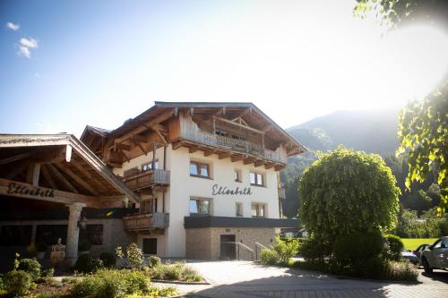 a large building with a balcony on top of it at Hotel Elisabeth, 4 Sterne Superior in Kirchberg in Tirol