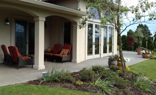 a porch of a house with chairs on it at Casale in Forest Grove