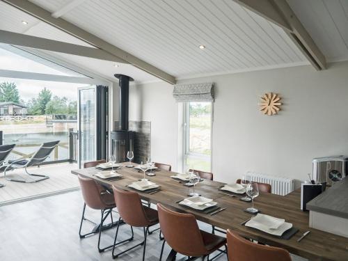 a dining room with a large wooden table and chairs at Brian Clough Lodge - Ukc4065 in Nunthorpe