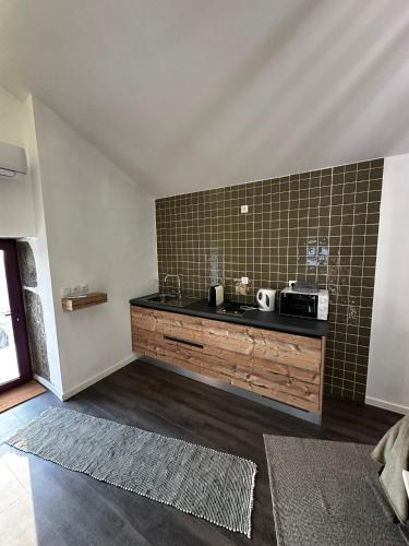 a kitchen with a sink and a counter top at Quinta de Águas Mortas in Gestaco