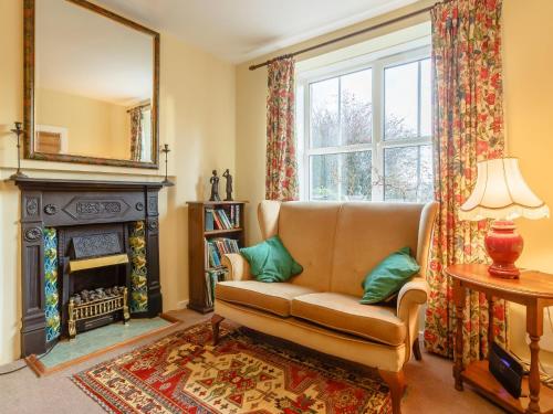a living room with a couch and a fireplace at Pen Y Crug in Beulah