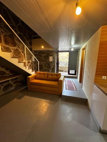 a living room with a couch and a staircase at Quinta de Águas Mortas in Gestaco