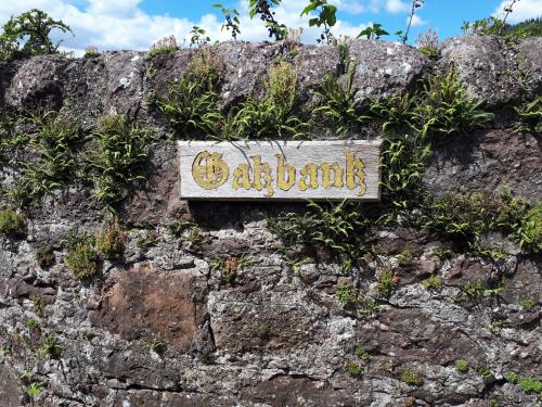 a sign on the side of a rock wall at Ben Ledi View in Callander