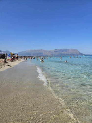a group of people in the water at a beach at Vento di Sicilia in Carini