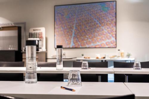 a table with two bottles and a pen on it at Abba Sants in Barcelona