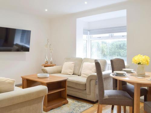 a living room with a couch and a table at Princess Court Apartment in Llanelli