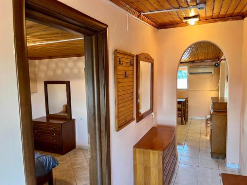 a hallway of a house with a mirror and a table at Makrygialos-Atlantis in Makrýgialos