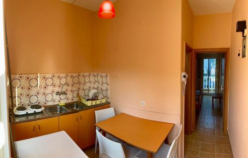 a kitchen with a sink and a wooden table at Makrygialos-Atlantis in Makrýgialos