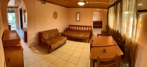 a living room with a couch and a table at Makrygialos-Atlantis in Makrýgialos