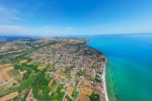an aerial view of a city next to the water at Makrygialos-Atlantis in Makrýgialos