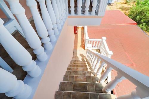 a staircase with white railings on a house at Makrygialos-Atlantis in Makrýgialos